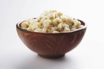 Closeup view of brown bowl of Hominy on white background — Stock Photo