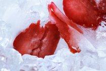 Sliced strawberry on ice — Stock Photo