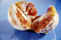 Peeled and halved fresh orange — Stock Photo