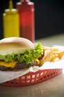 Cheeseburger and potato fries — Stock Photo