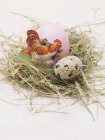 Vista de primer plano del huevo de Pascua y el huevo de codorniz en el nido de Pascua - foto de stock