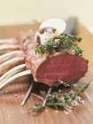 Rack of lamb with herbs and quail egg — Stock Photo