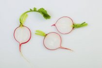 Slices of radish with stalks — Stock Photo
