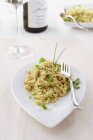 Couscous with herbs served on white plate — Stock Photo