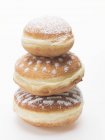 Three doughnuts dusted — Stock Photo