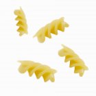 Four fusilli pasta pieces — Stock Photo