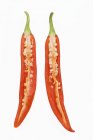 Chilli, halved over white surface — Stock Photo