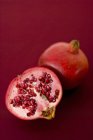Fresh pomegranate and half — Stock Photo