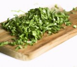 Shredded parsley on chopping board — Stock Photo