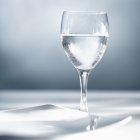 Glass of water with ceramic plate — Stock Photo