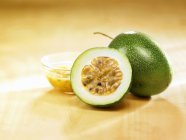 Passion fruits on yellow surface — Stock Photo