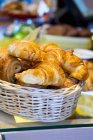 Woven basket of croissants — Stock Photo