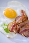 Fried bacon stripes and egg — Stock Photo