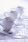 Closeup view of three cups of Espresso with glasses of water — Stock Photo