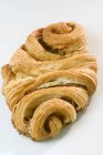 Closeup view of Franzbrtchen bun with cinnamon on white surface — Stock Photo