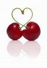 Pair of cherries forming heart — Stock Photo