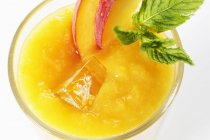 Peach smoothie with peach slices — Stock Photo