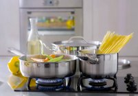 Vegetables and spaghetti in pans — Stock Photo