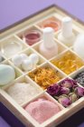 Elevated view of various beauty products and flowers in type case — Stock Photo