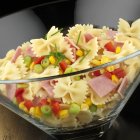 Farfalle with ham and vegetables — Stock Photo
