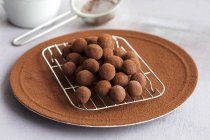 Chocolate balls on rack — Stock Photo