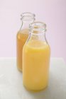 Glass bottles with fruit juice — Stock Photo