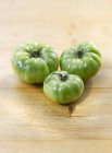 Three green tomatoes — Stock Photo