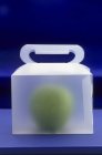 Green apple in carrying box — Stock Photo