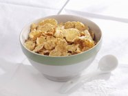 Bowl of cornflakes with spoon — Stock Photo