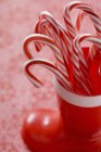 Candy canes in plastic boot — Stock Photo