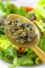 Pumpkin seeds on spoon — Stock Photo
