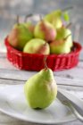 Pears in red basket — Stock Photo