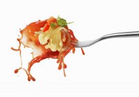 Pasta and squirted tomato sauce — Stock Photo
