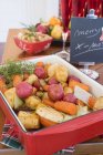 Roasted root vegetables on Christmas table — Stock Photo