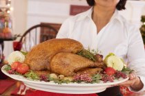 Woman serving roast turkey — Stock Photo