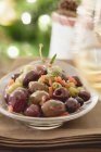 Marinated olives  on white plate over towel — Stock Photo