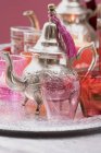 Teapot, glasses and windlights on tray — Stock Photo