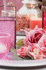 Closeup view of decorations including windlights, roses and candles — Stock Photo