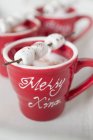 Marshmallows on sticks on cups — Stock Photo