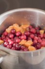 Closeup view of cranberry sauce with oranges in pan — Stock Photo