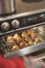 Closeup view of Popovers on rack in oven — Stock Photo