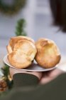 Hands holding plate of popovers — Stock Photo
