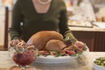 Woman with roast turkey — Stock Photo