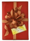 Closeup top view of red gift box with bow and geschenk gutschein words on tag — Stock Photo