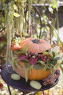 Pumpkin decorated with flowers — Stock Photo