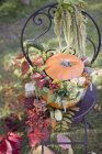 Pumpkin decorated with flowers — Stock Photo