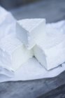 Sheep's cheese on paper — Stock Photo
