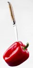 Knife sticking into red pepper — Stock Photo