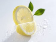 Slice and wedge of lemon — Stock Photo