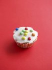 Cupcake with colorful chocolate beans — Stock Photo